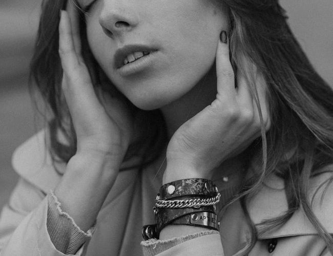 Serene person sitting in a relaxed pose with soft lighting